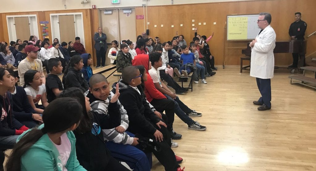 A surgeon talks with students at Gulf Elementary School.